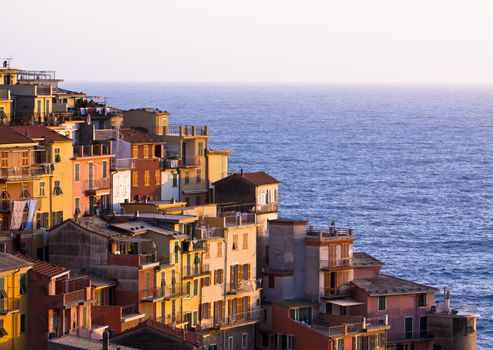Colourful house frontings glowing in the warm evening sunlight. Cinque Terre - Italy.