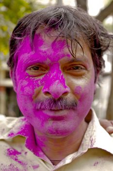 Man covered with paint for Holi festival, New Delhi, India.