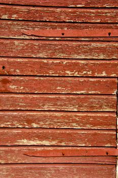 Fragment of old brown painted building wall made of wooden planks.