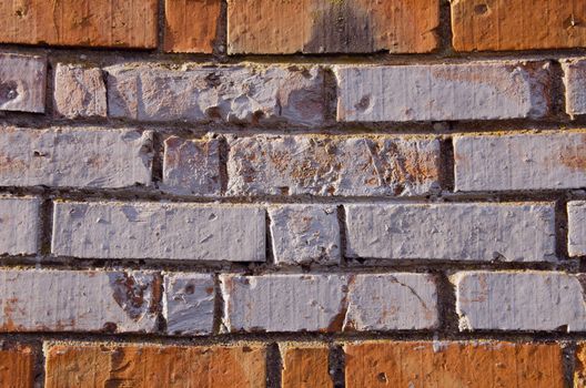 Wall made of red and colored bricks. Architectural decision.