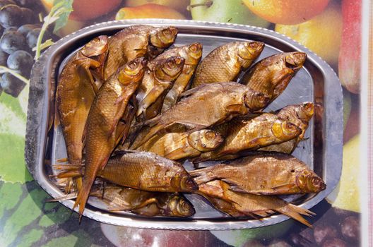 Metal tray loaded with freshly bloated fish.