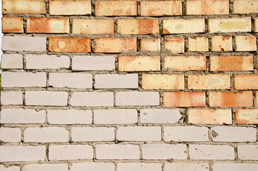 Wall made of red and white brick. Architectural decision.