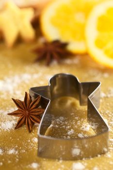 Star anise with angel shaped cookie cutter on dough (Selective Focus, Focus on  the middle of the anise)