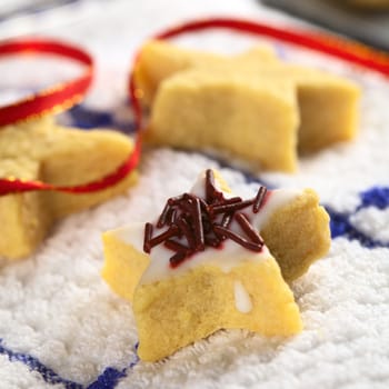 Star shaped cookie with sugar icing and chocolate sprinkles (Selective Focus, Focus on the middle of the cookie)