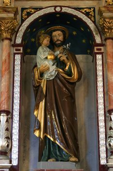 Saint Joseph holding baby Jesus