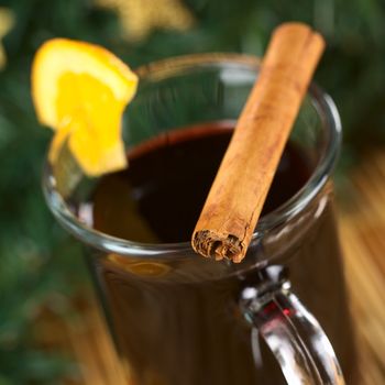 Hot mulled wine with garnished with cinnamon stick (Very Shallow Depth of Field, Focus on the front of the cinnamon stick)