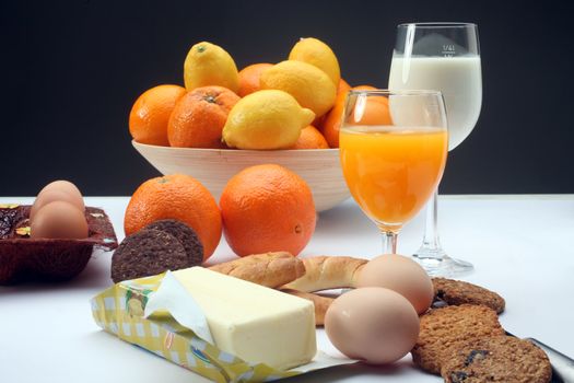 Breakfast with juice, milk, fruits and eggs