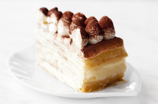 Portion of Tiramisu Mille crepe on a plate