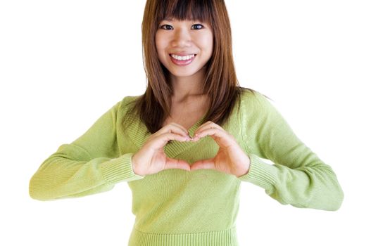 A woman's hands forming a heart symbol on chest
