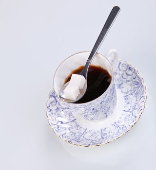cup of coffee with a spoon of sugar
