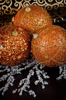 Christmas ball baubles with orange, silver and gold decoration.