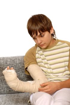 sad teenage caucasian boy with broken arm bone