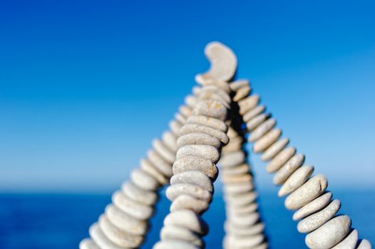 Pyramidal group of small pebbles in the balance on the seacoast