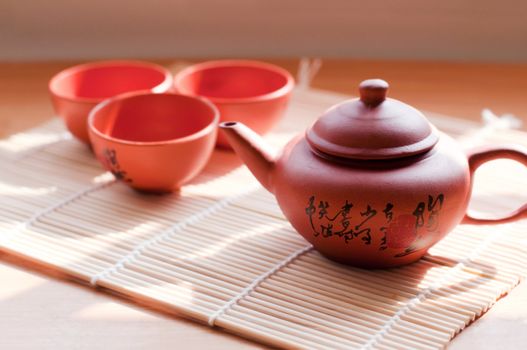 Chinese ceramic teapot and cups. The Chinese word on the pot is a poem.