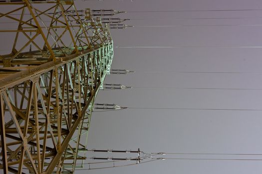Pylon of high-voltage transmission line at night.