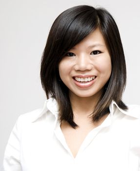 Young Asian woman on grey background