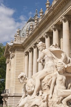 Stone statue at the entrance to the Petit Palace in Paris, France