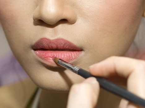 A young woman applying makeup