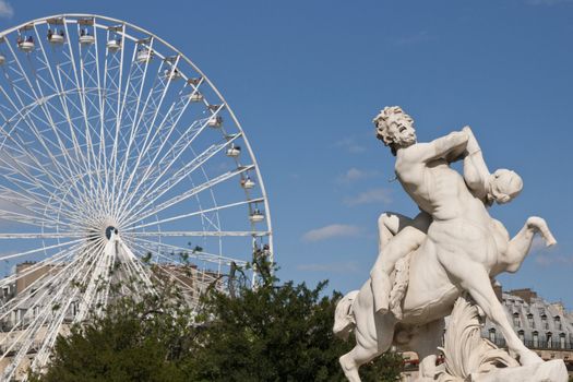 Statue and white ferris wheel in the Jardin des Tuileries, Paris, France