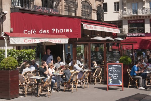 Street cafe filled with people in Paris, France