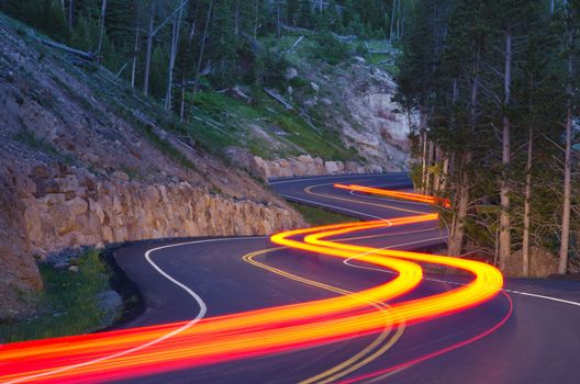 Twilight traffic on the Grand Loop Road in summer, Yellowstone National Park, Park County, Wyoming, USA