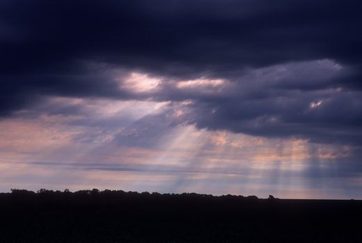 Rays of light break through morning storm clouds, Lancaster County, Nebraska, USA