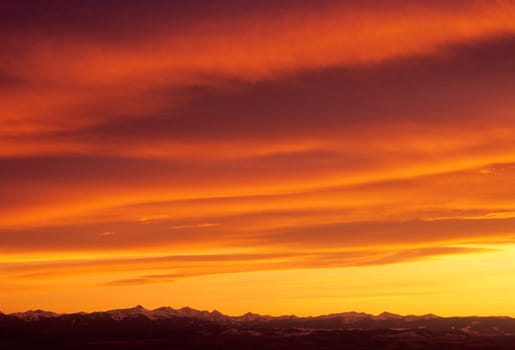 A fiery sunset sky above the Madison Mountain Range, Gallatin County, Montana, USA