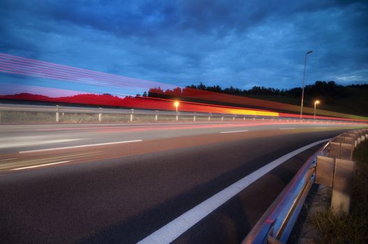Fast car passing by highway, slow shutter