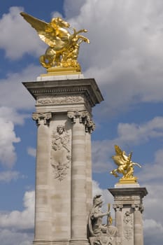 Golden statues of winged horses on top of pillars decorate the Pont Alexandre III in Paris, France.