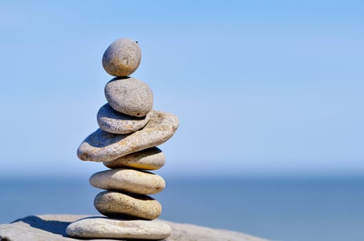 Pile of pebbles in the balance on the seacoast