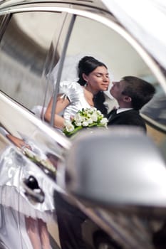 kiss in the reflection of a car