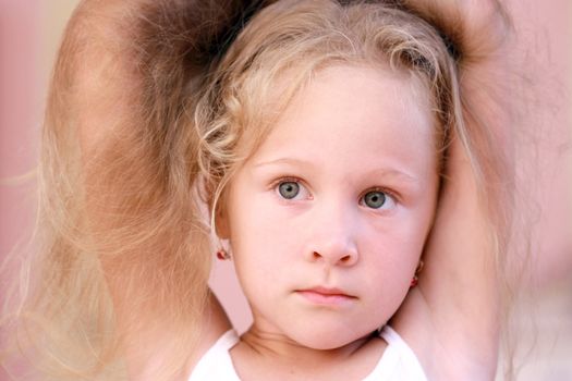 portrait of a beautiful little girl with blond hair