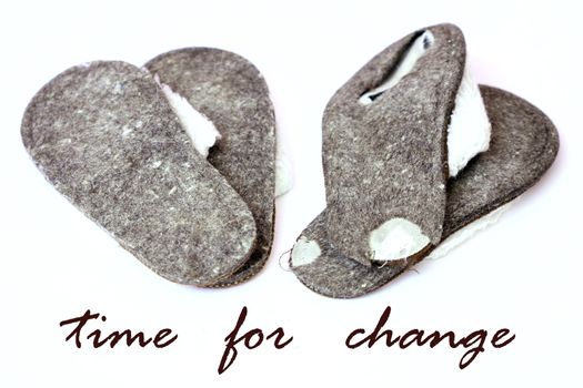 worn-out slippers with the words time for change