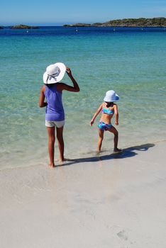 kids standing on the beach