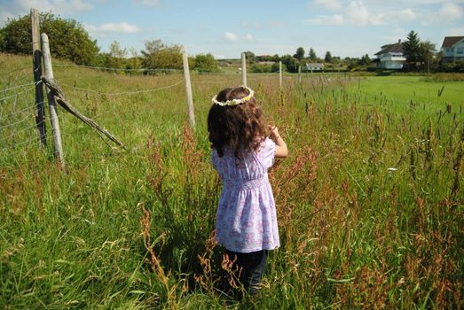 little girl in green field