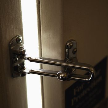 Close-up of security lock on motel or hotel room door.