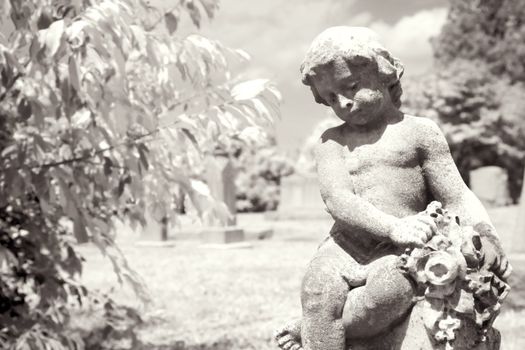 Infrared graveyard scenic with cherub statue.