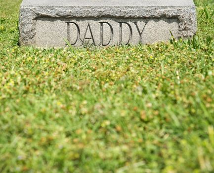 Gravestone marker with word "Daddy" on it.