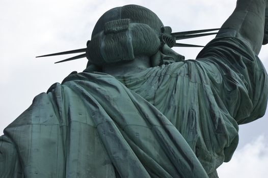 Close-up, upper section, Statue of Liberty from back showing head and part of right arm against the sky, New York City, USA