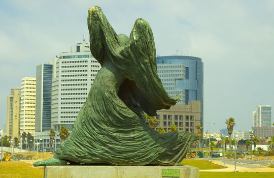 Sculpture "Angel" against modern building. 
Tel-Aviv. Israel.
