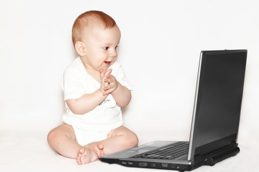 Clapping baby with notebook