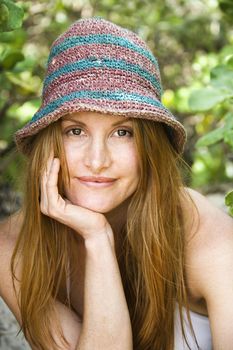 Portrait of pretty redheaded woman wearing hat.