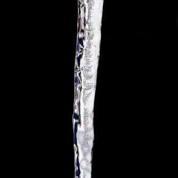 Close view of a icicles with wonderful structures isolated on a black background