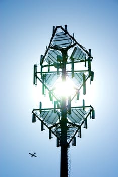 Close-up of a telecommunications tower back lit by sun
