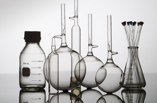 Chemistry recipients in glass on a glass table