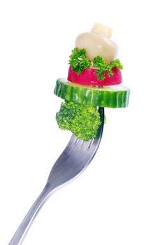 Fresh vegetables on a fork isolated on white background