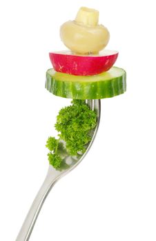 Fresh vegetables on a fork isolated on white background