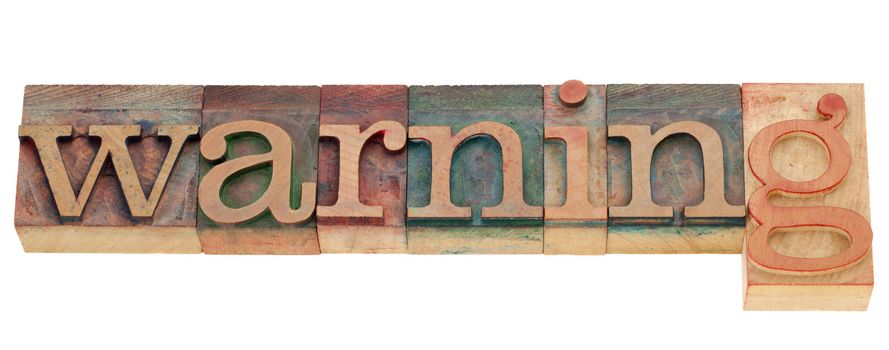 warning - isolated word in vintage wood letterpress printing blocks