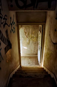 Staircase and exit door of an abandoned house.