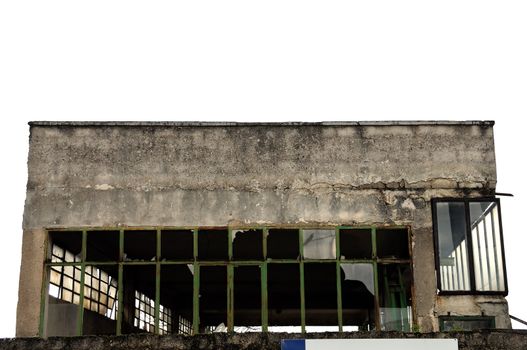 Broken windows facade of an abandoned warehouse.